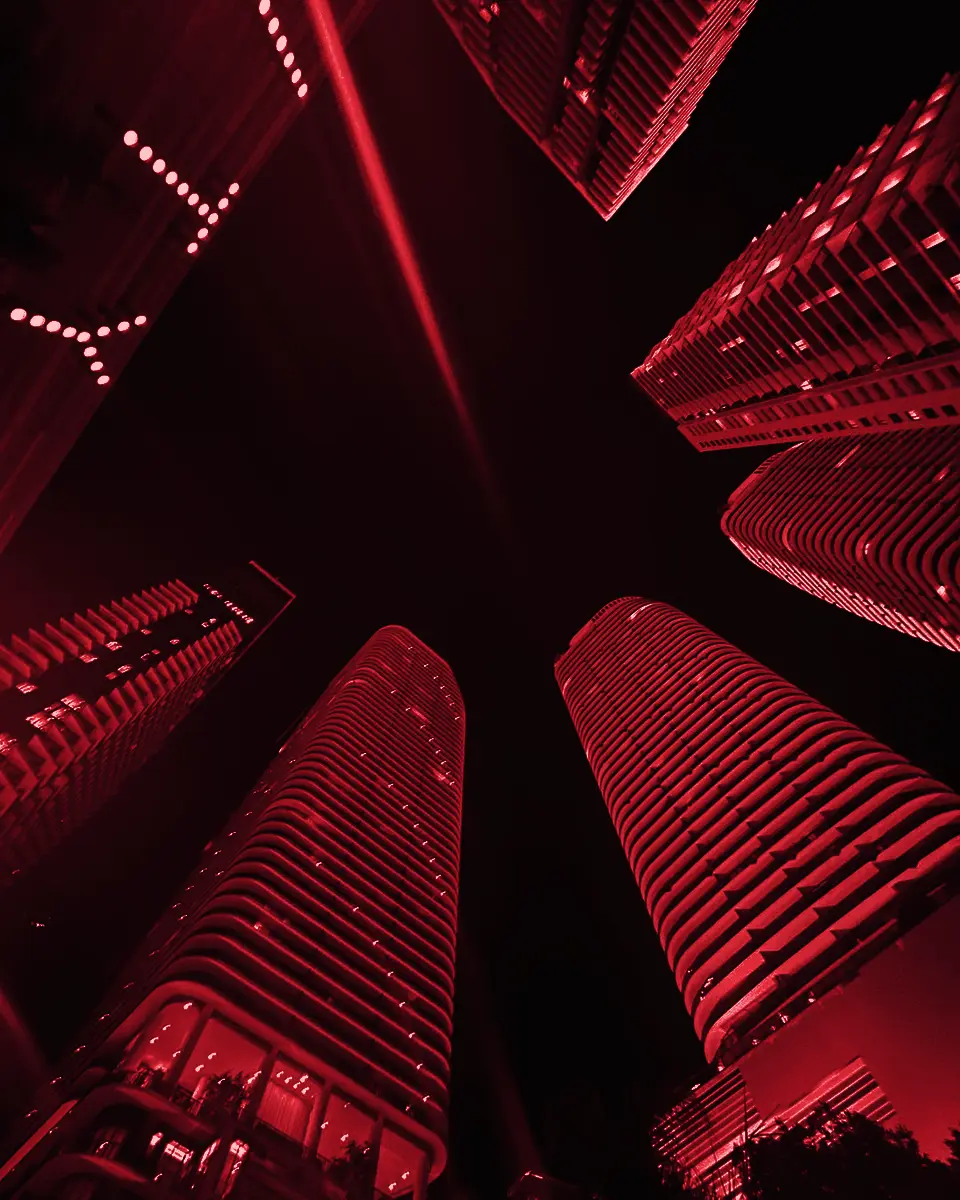 Looking straight up between two towers at night